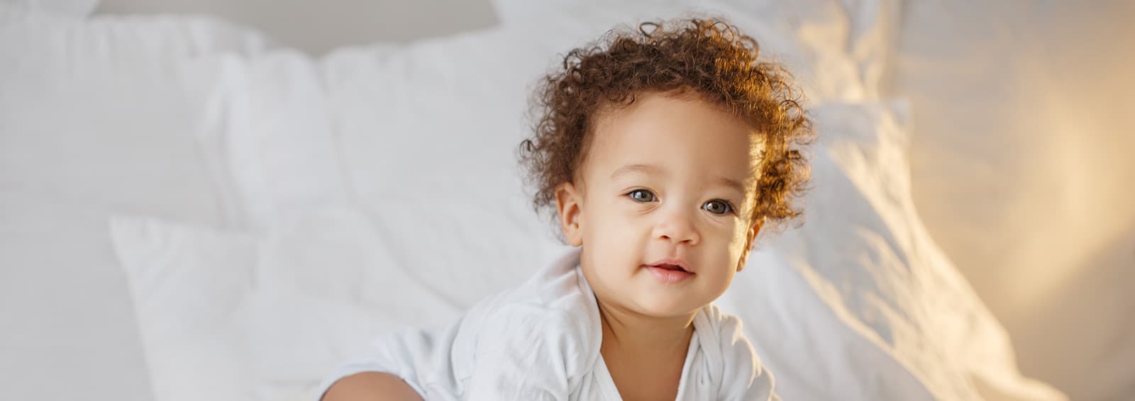 baby crawling on bed